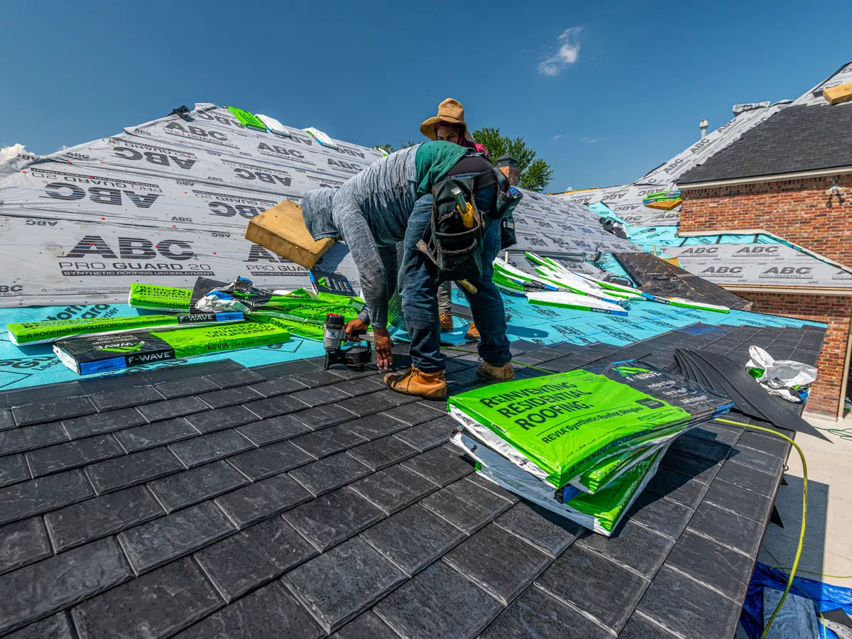 Roofer installing roofing material